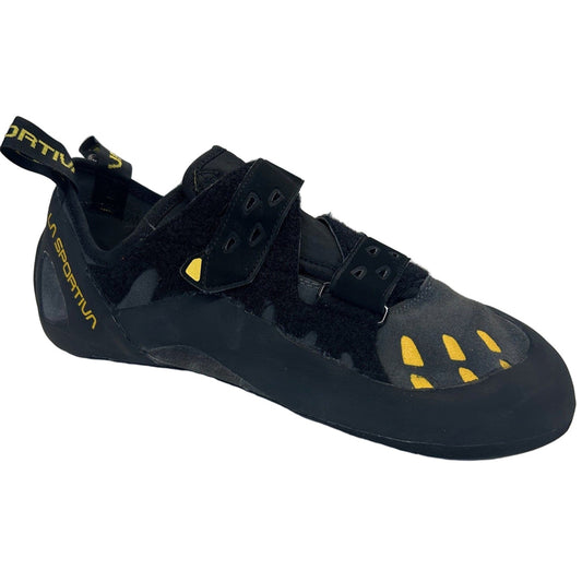 Black climbing shoe with yellow accents on a white background